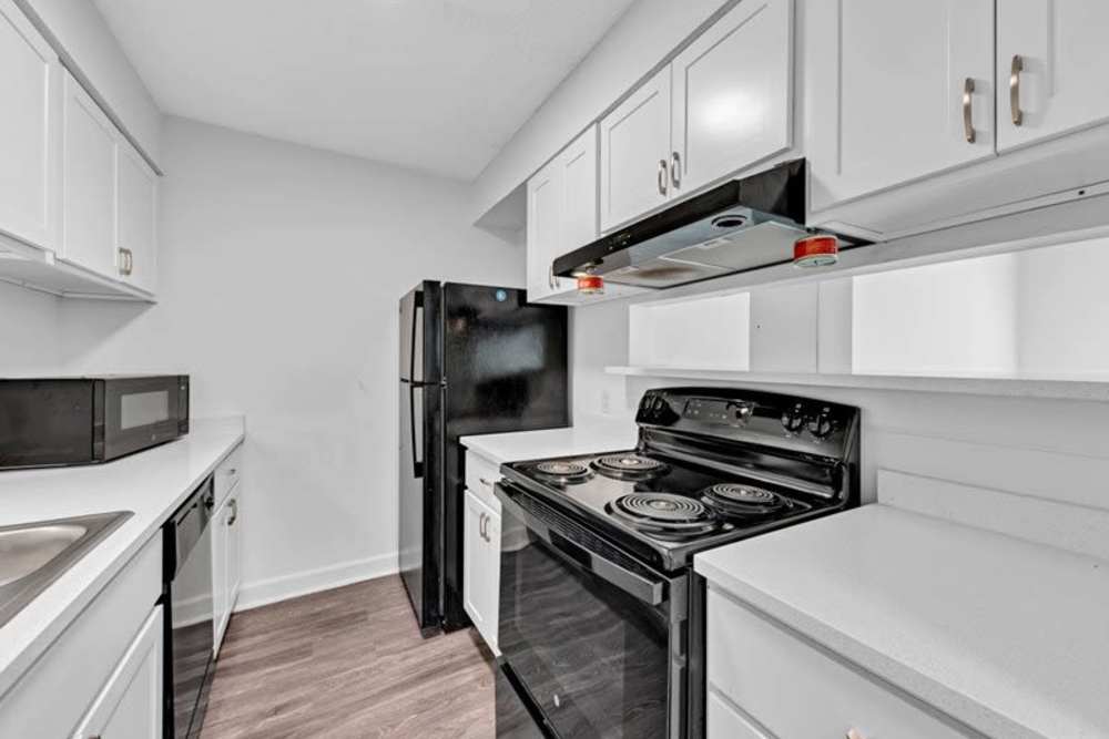 Kitchen with wooden cabinets at Canebreak Apartments in Summerville, South Carolina