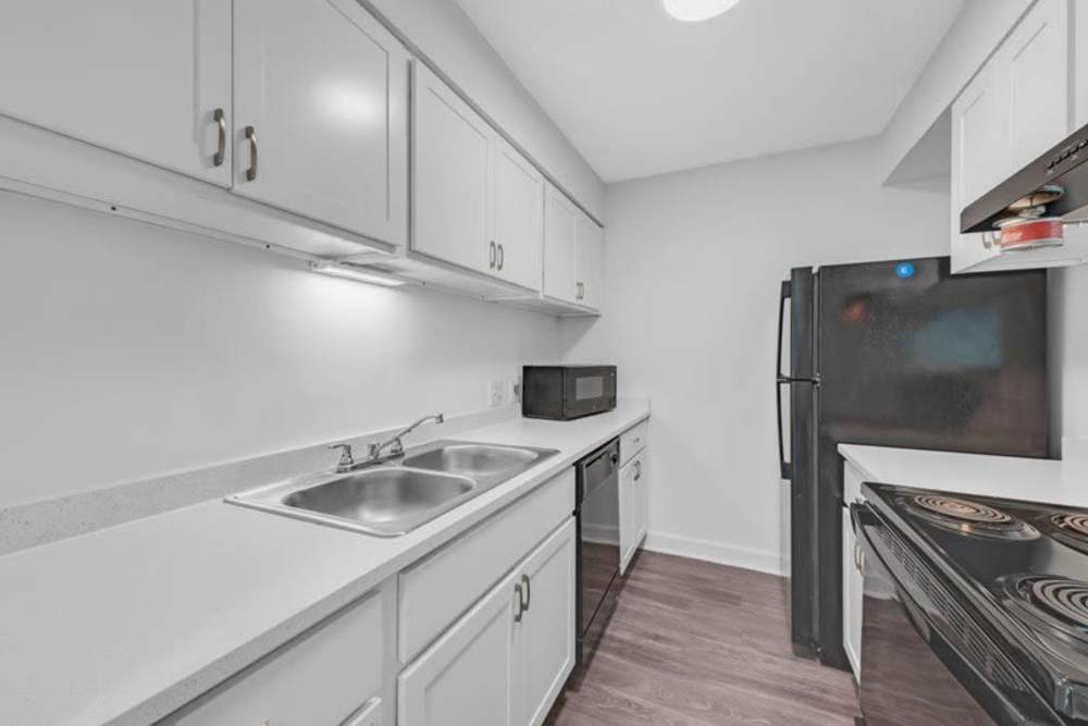 Kitchen with refrigerator and bright lighting at Canebreak Apartments in Summerville, South Carolina