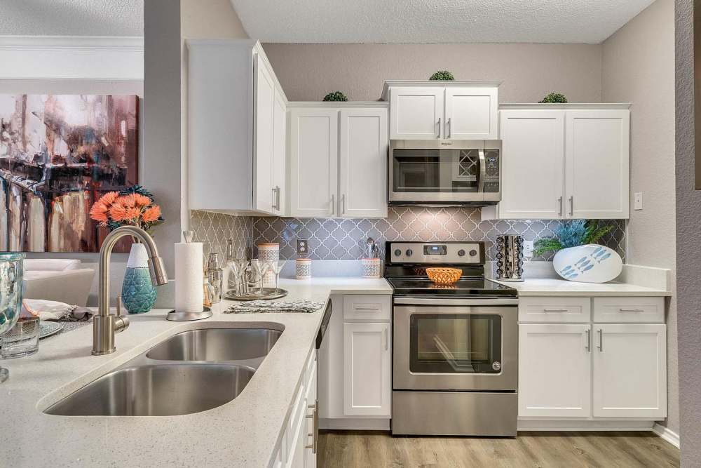 Kitchen with white cabinets and granite countertops at Dawson in Orlando, Florida