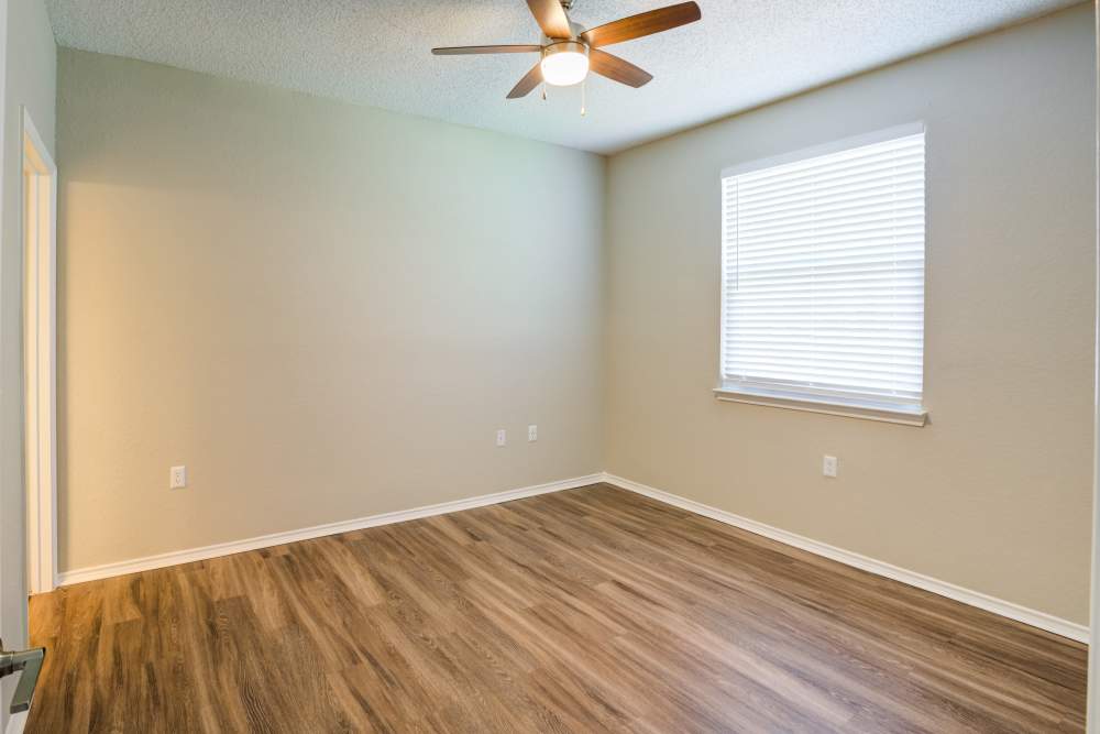 Unfurnished bedroom with wood flooring and ceiling fan at Dawson in Orlando, Florida