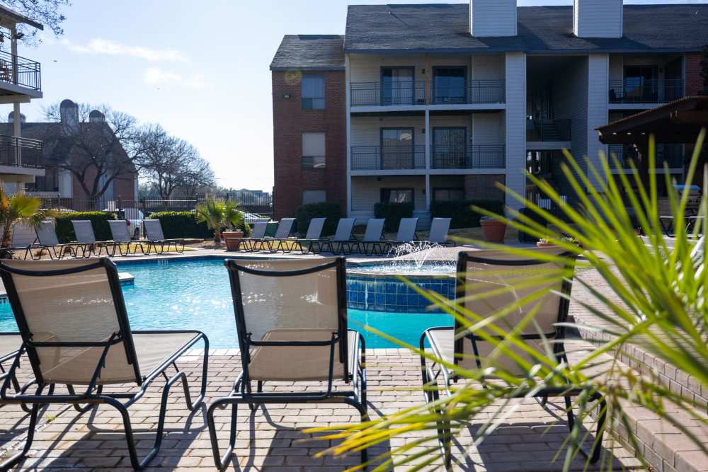 Lounge chairs near pool side at Rivercrest in Waco, Texas 