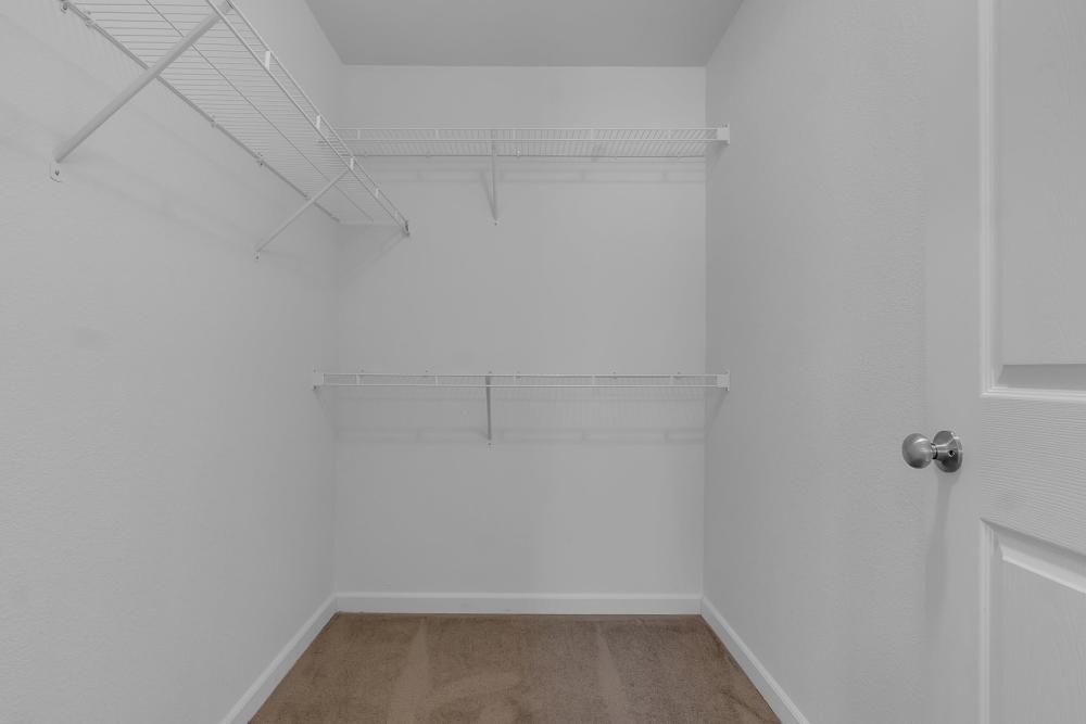 Spacious walk-in closet with ample shelving and neutral tones at Wickham Gardens in Sapulpa, Oklahoma