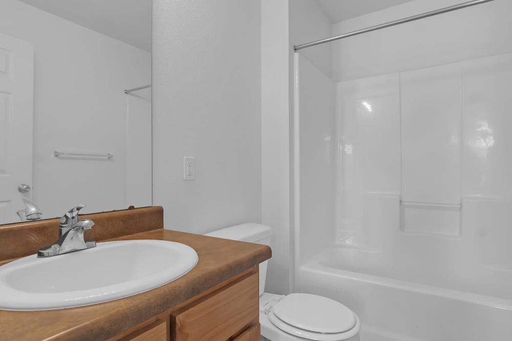 Bright bathroom with modern fixtures and clean lines at Wickham Gardens in Sapulpa, Oklahoma