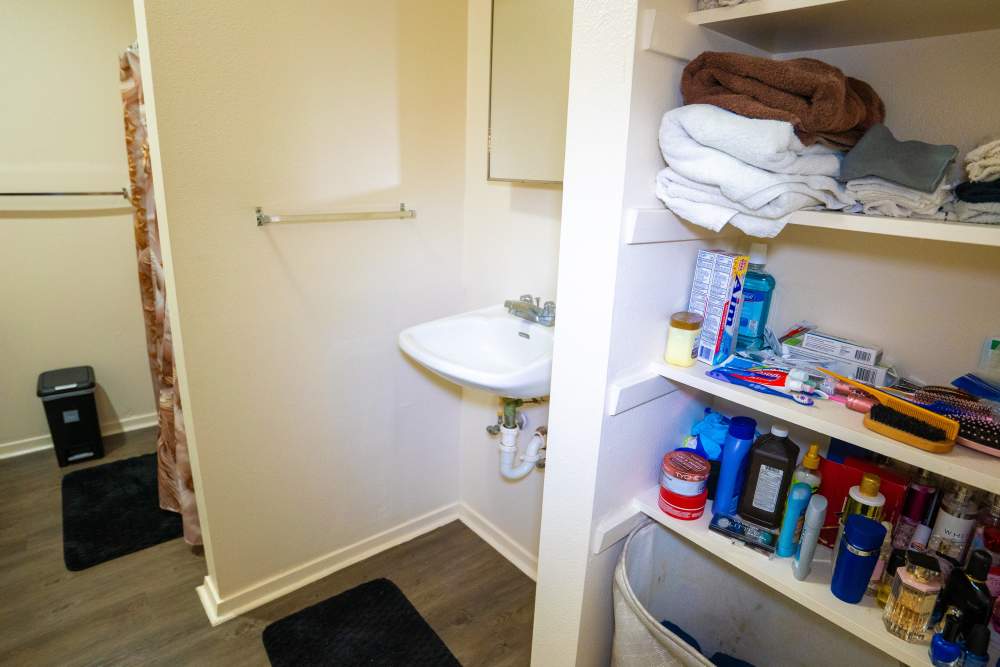 Storage shelves in apartment bathroom at Willowbrook II in Lafayette, Louisiana