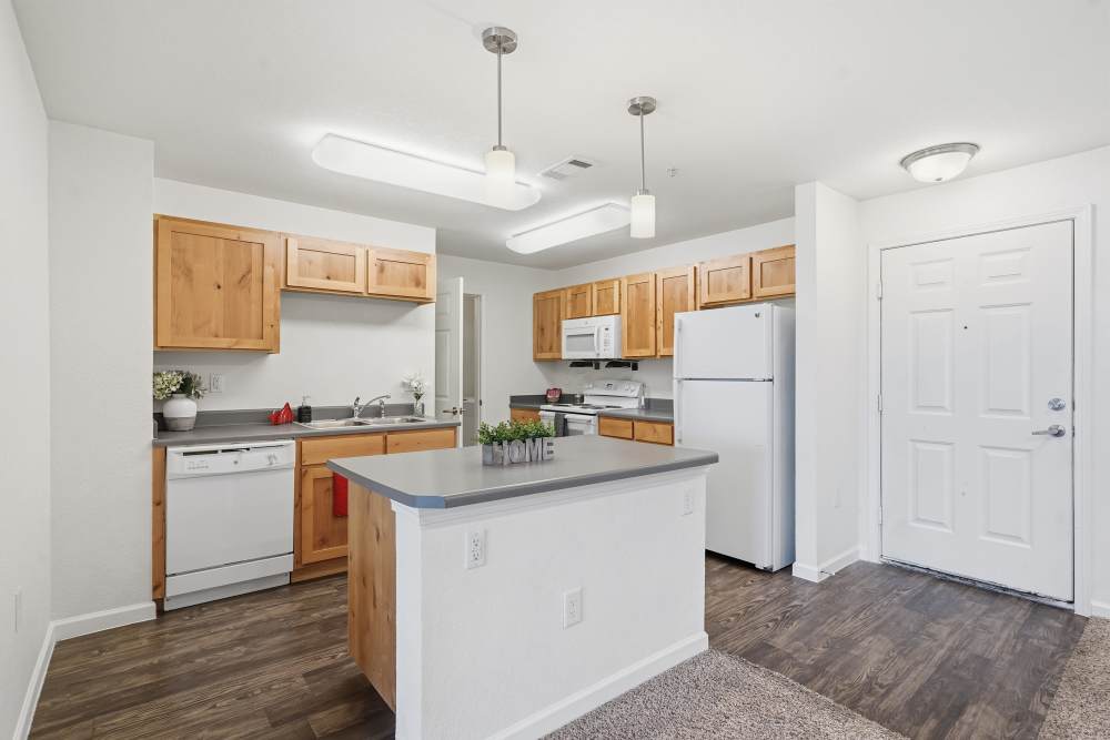 Upgraded kitchen with modern appliances and warm wooden cabinetry at Wood Falls in Lebanon, Tennessee