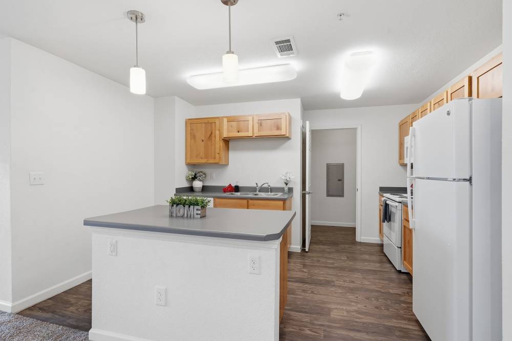 Modern kitchen with sleek countertops and warm wooden cabinetry at Wood Falls in Lebanon, Tennessee