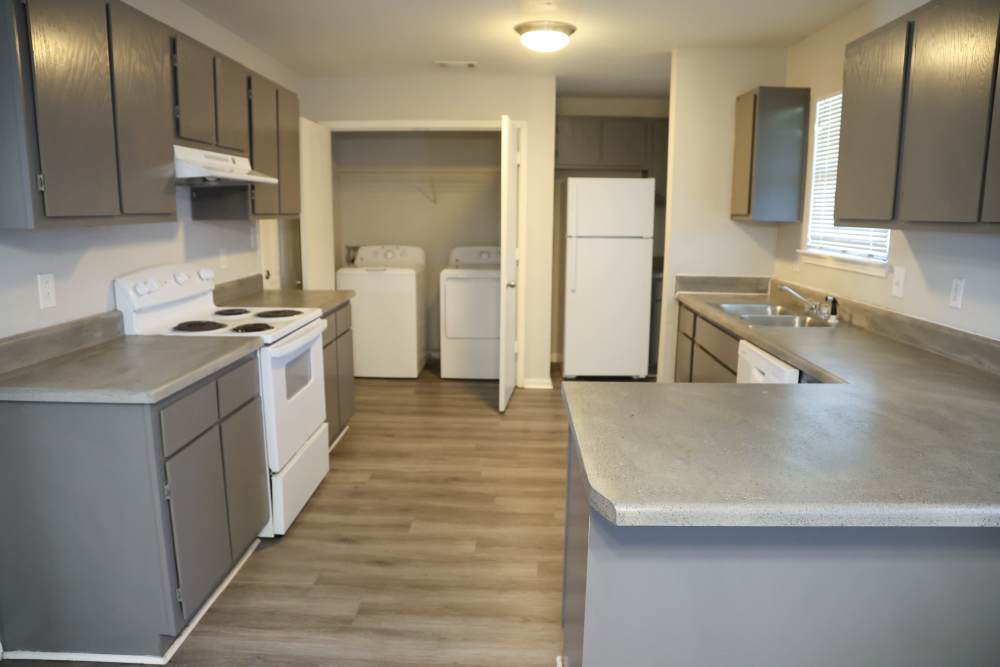 Kitchen with wooden cabinets and stainless-steel appliances at Horizon Apartments in Jackson, Mississippi