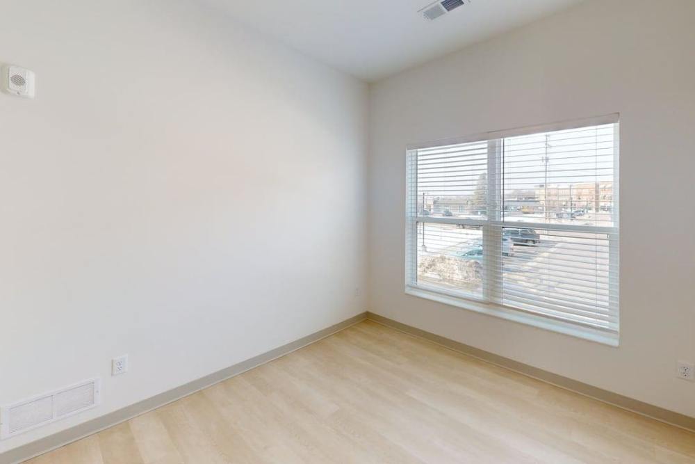 Bedroom with large window and light hardwood flooring at Terra Station, Hudsonville, Michigan