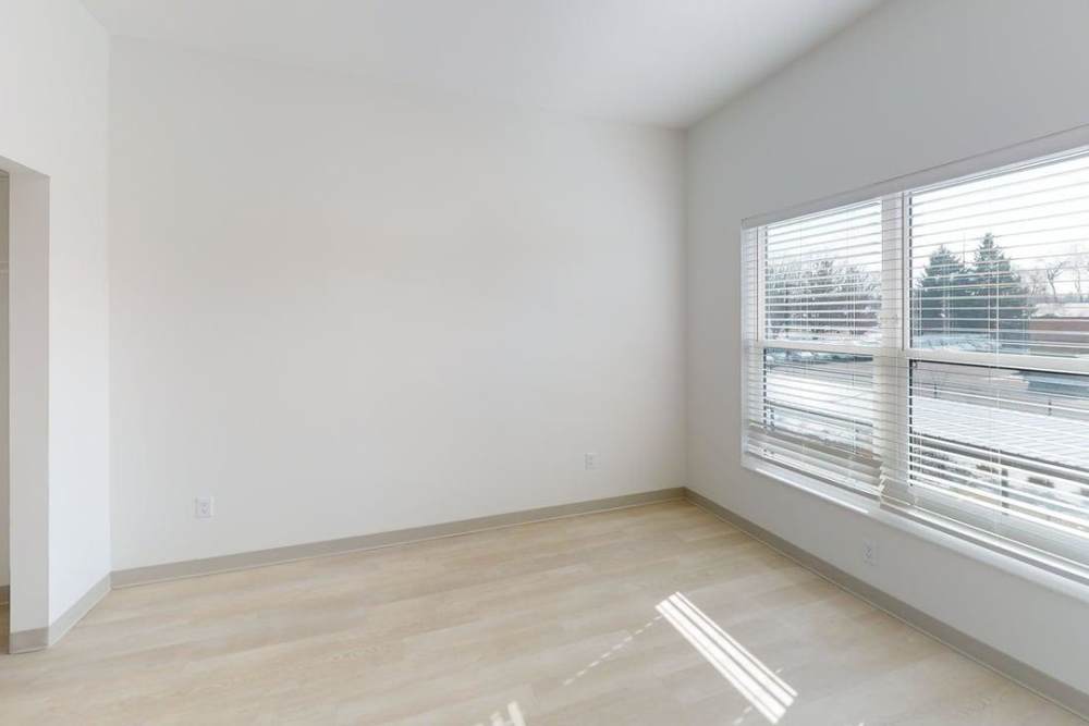 Sunlit bedroom with wide windows and light flooring at Terra Station, Hudsonville, Michigan