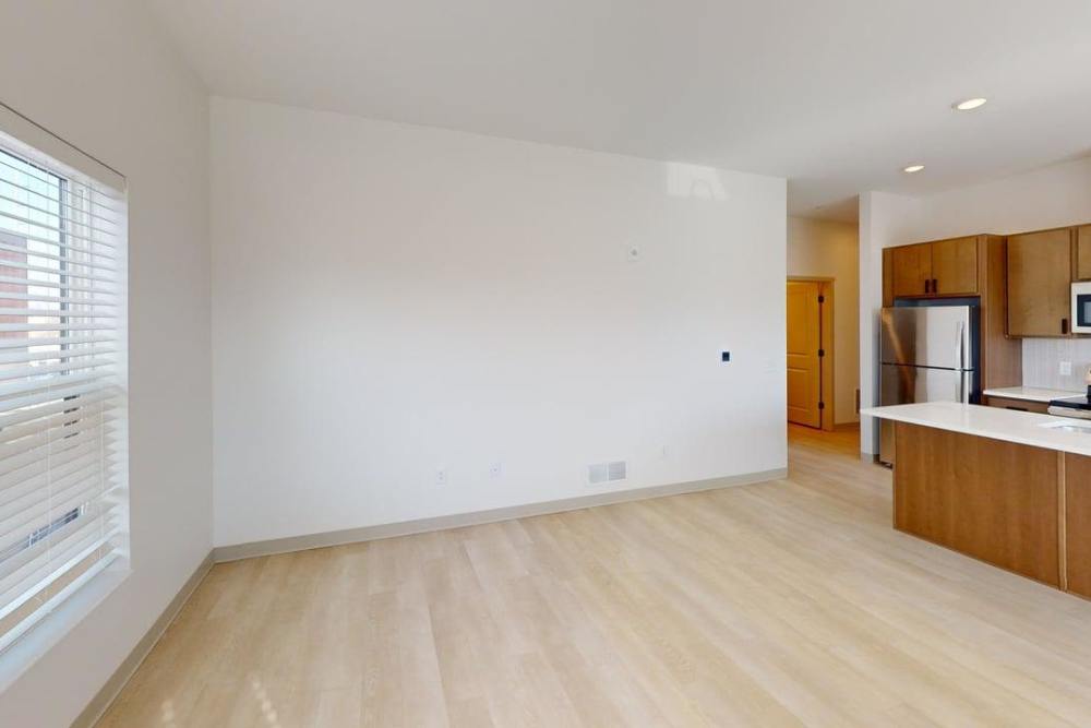 Open living area with kitchen view and bright windows at Terra Station, Hudsonville, Michigan