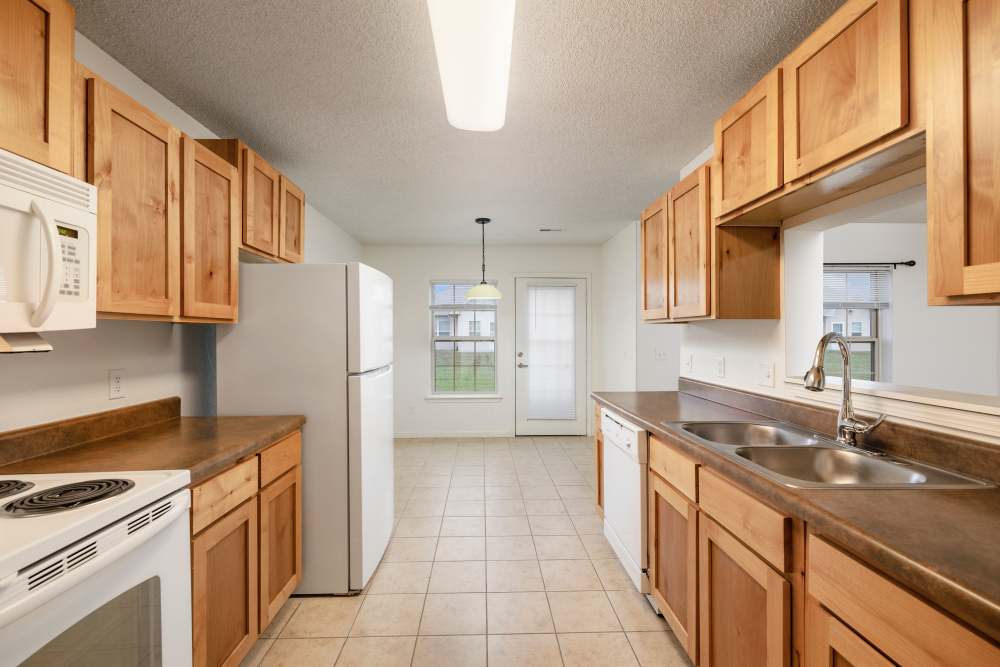 Spacious kitchen with white appliances at Oaklawn Estates in Rogersville, Missouri 