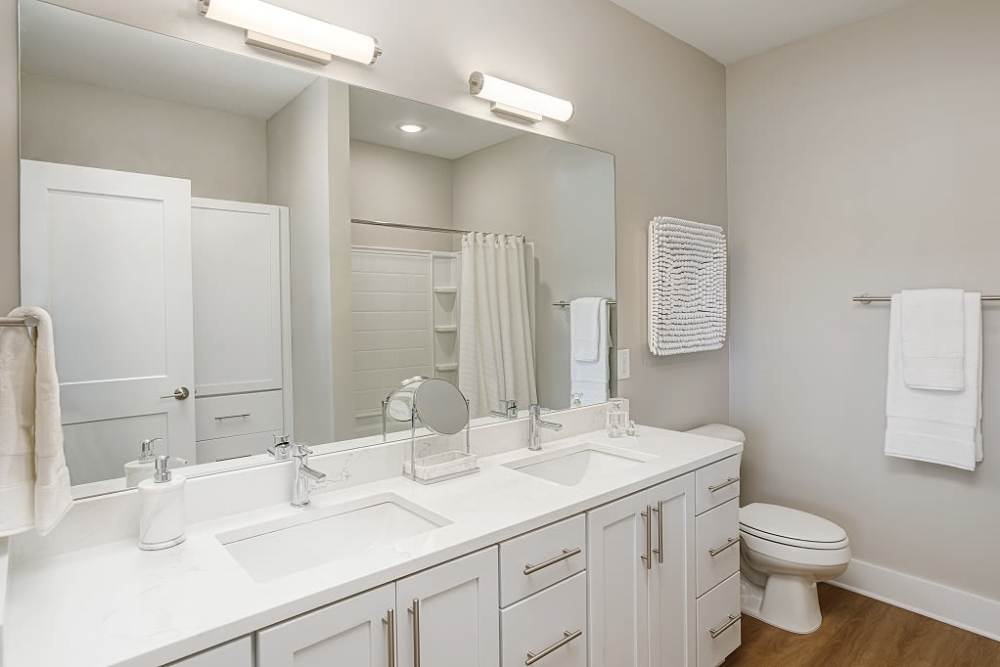 Bathroom with dual sink at City Limits Apartments in Columbia, Tennessee