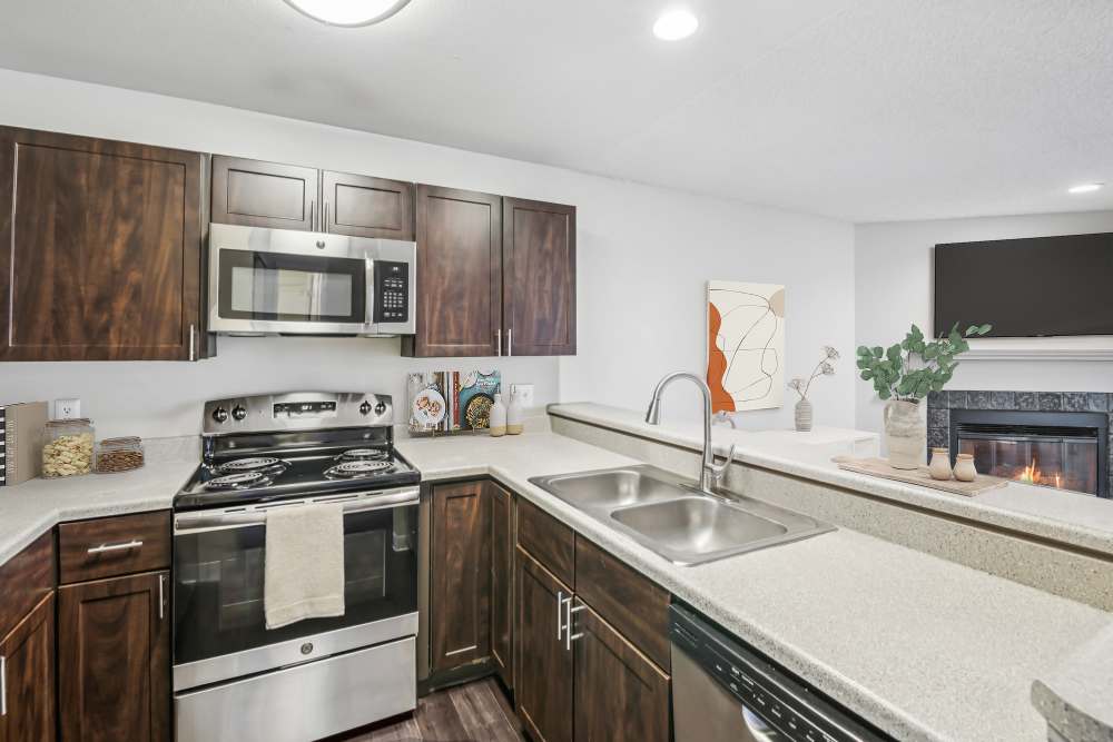 Brown Renovated Kitchen Cabinetry at Bluesky Landing Apartments in Lakewood, Colorado