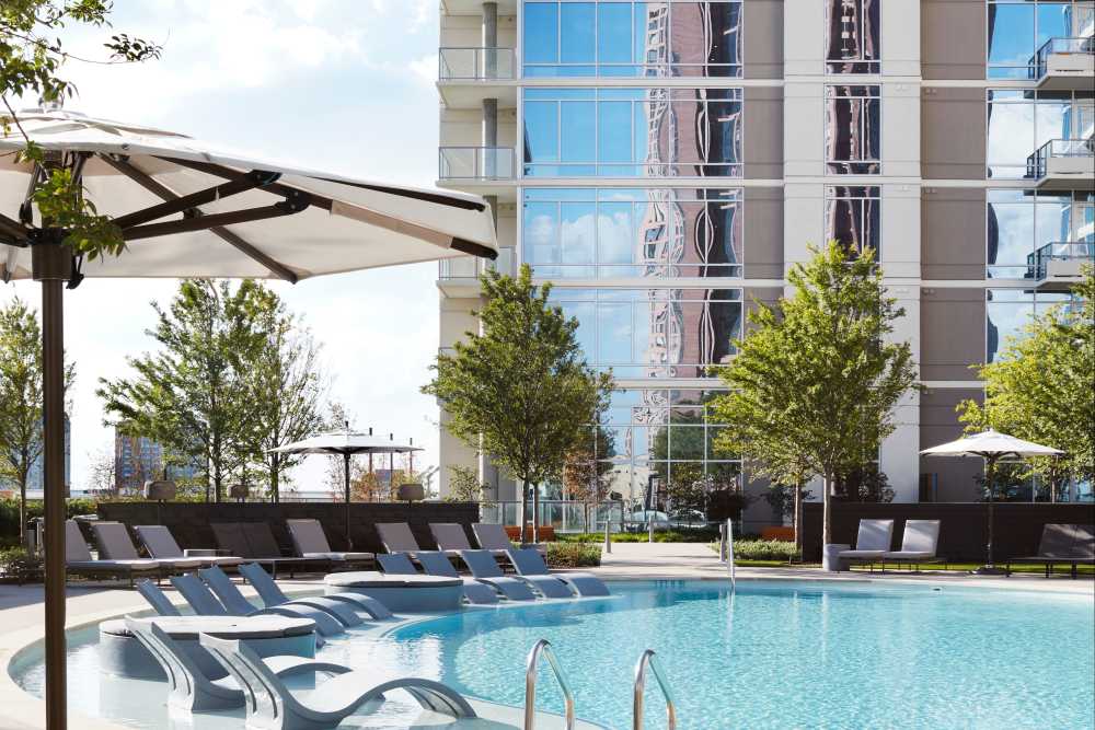 Pool area with lounge seating at Ardan in Dallas, Texas