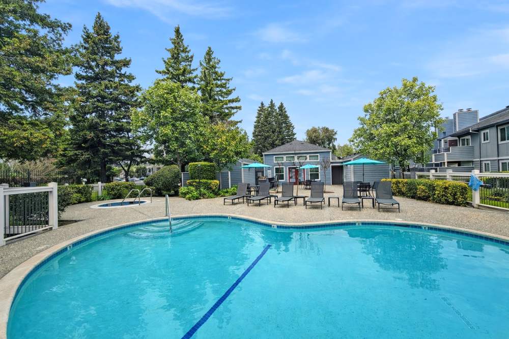 Pool area with lounge chairs at Bennington Apartments in Fairfield, California