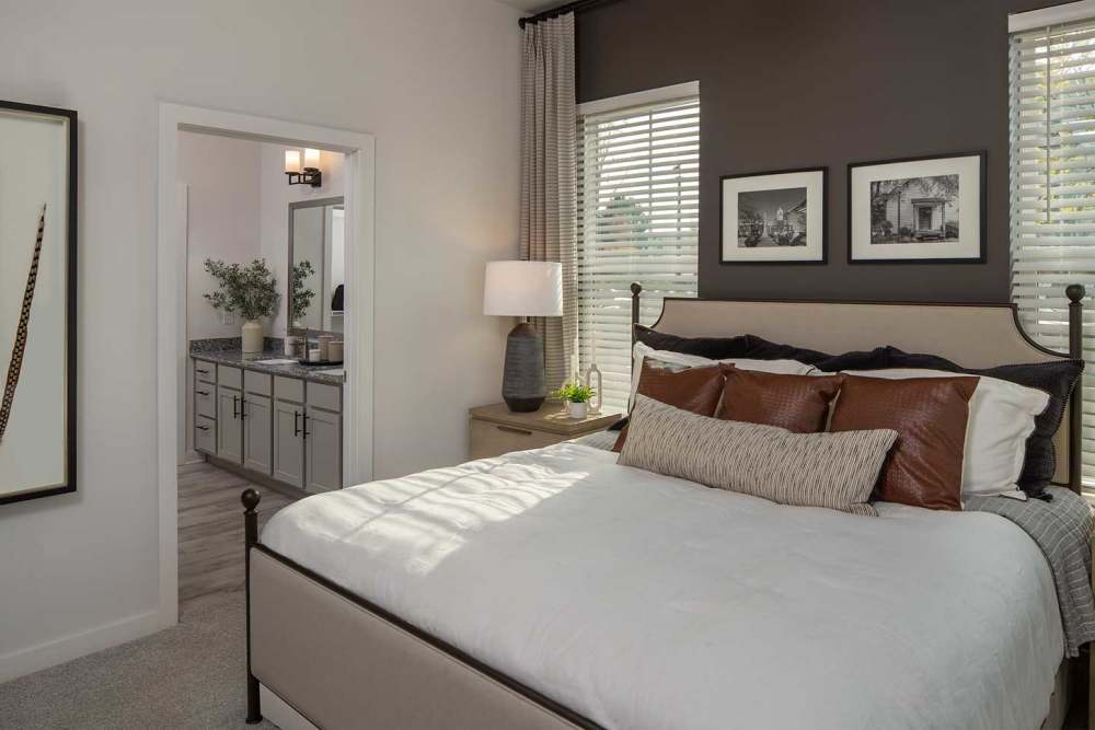 Bedroom with a cozy bed at Arden at South Point Apartment Homes in McDonough, Georgia