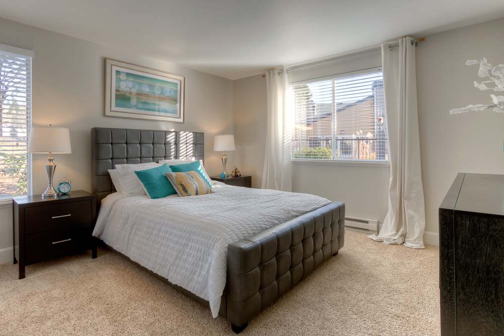 Bedroom with window  at Newport Crossing Apartments in Newcastle, Washington