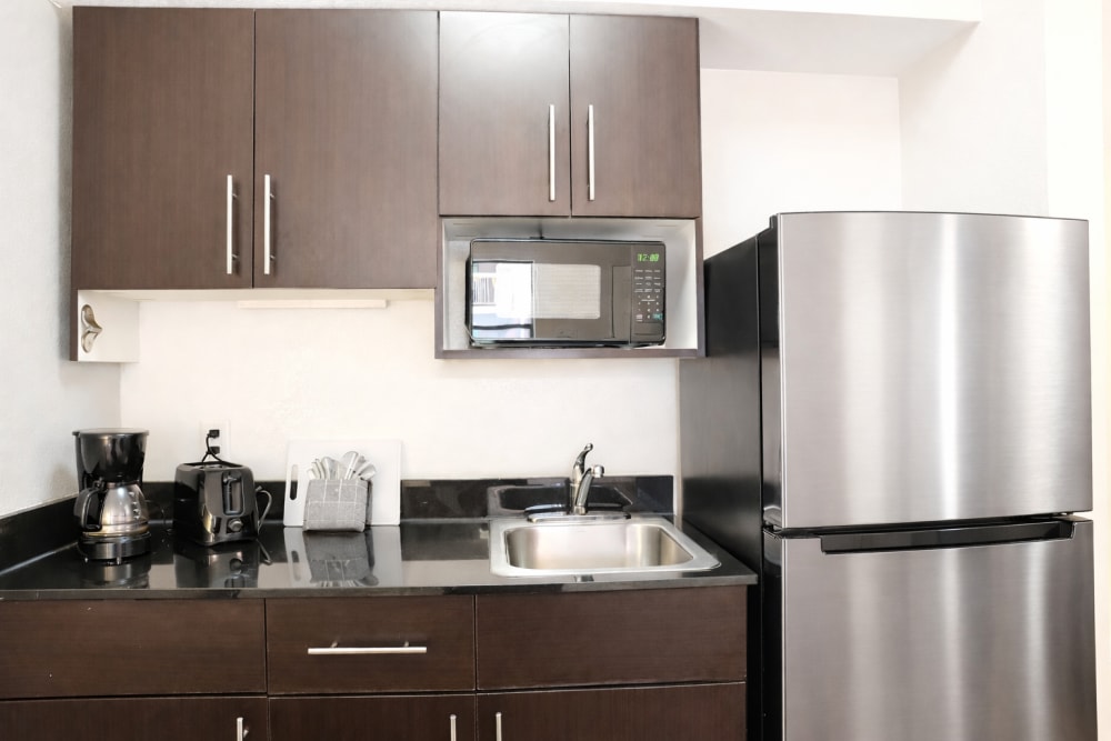 Model studio kitchen with stainless steel appliances at Trailhead Flats in Colorado Springs, Colorado