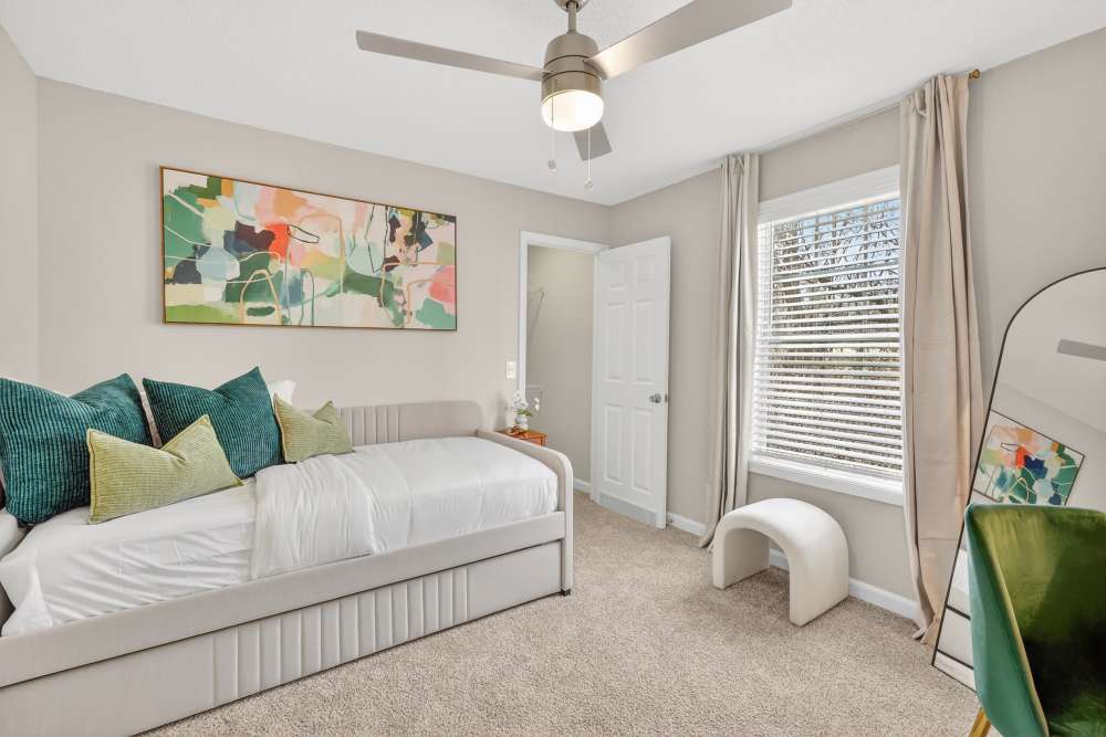 Elegant bedroom with natural light and comfortable living space in a Saddlebrook apartment home.