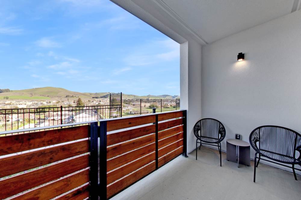 Patio with two chairs and scenic mountain views at Domaine at Napa Junction in American Canyon, California