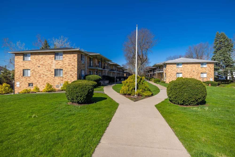 Sidewalk with grass lawn at Eastway Manor Apartments in Webster, New York