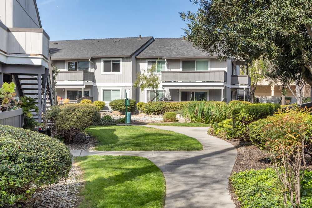 Exterior walkways with lush greenery at Sofi Waterford Park in San Jose, California