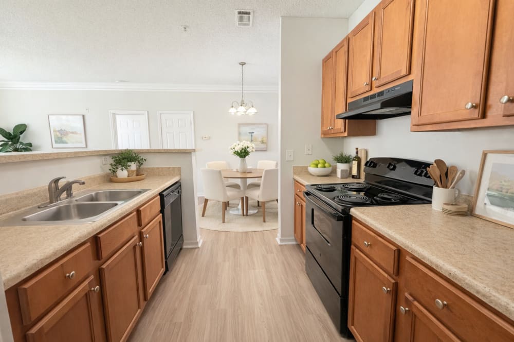 Modern kitchen with stainless steel appliances and breakfast bar at Walden Creek in Greenville, South Carolina