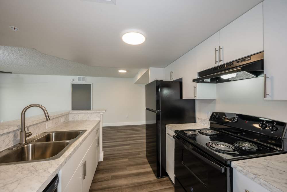 Fully equipped kitchen with wood style flooring at Ernie Martin Villas in Miami, Florida