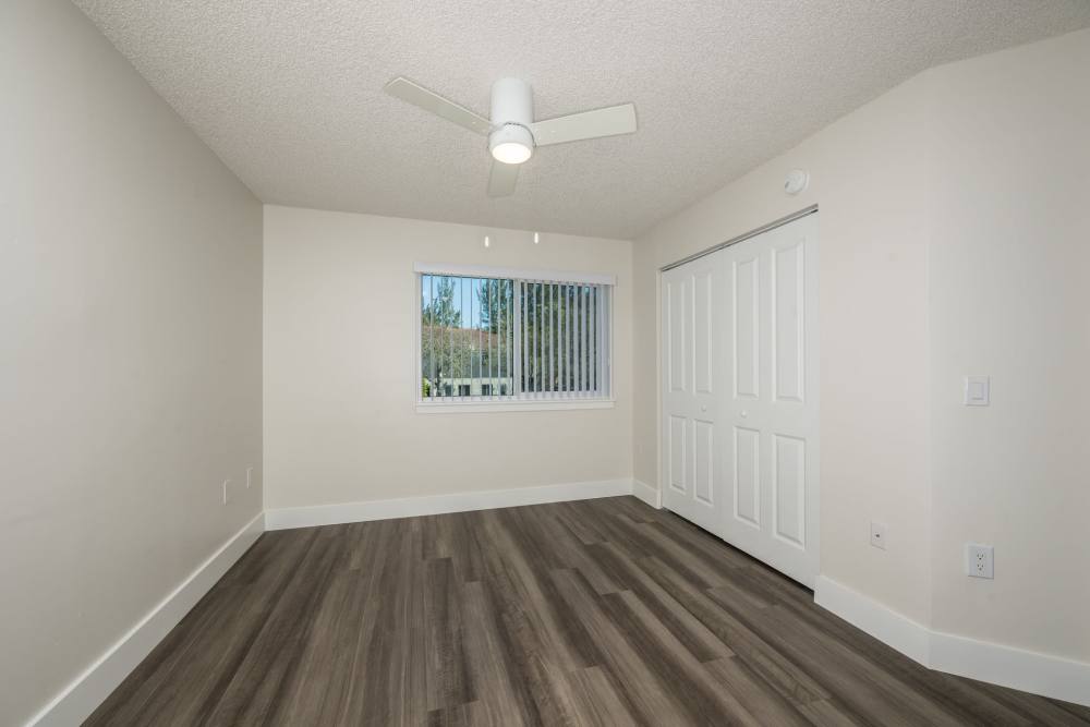 Model bedroom of apartment with spacious walk-in closet at Ernie Martin Villas in Miami, Florida