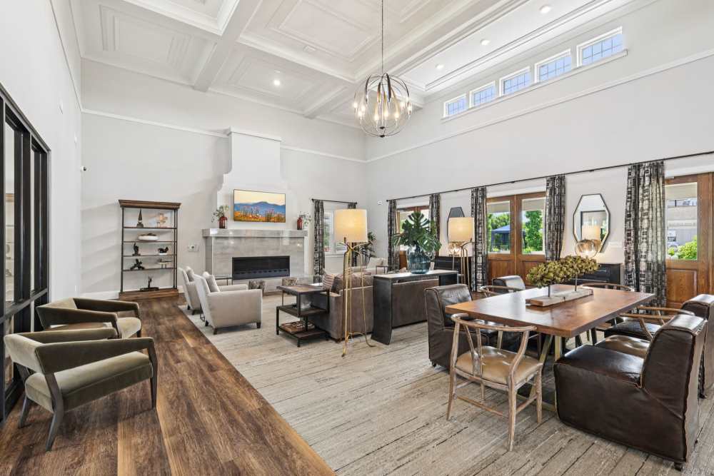 Lounge with dining table, multiple seating areas, and high ceiling with skylight windows at The Drake in Bowling Green, Kentucky
