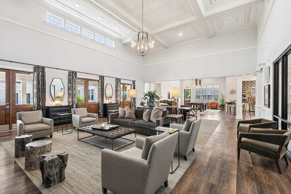 Spacious lounge with high ceiling, multiple seating areas, and large windows at The Drake in Bowling Green, Kentucky