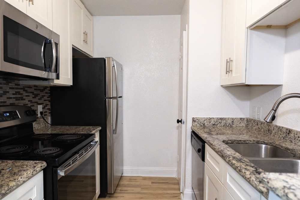Kitchen with dishwasher at Lakeshore Villa Apartments in Rowlett, Texas