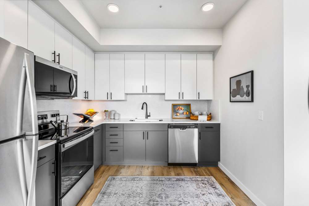 Modern kitchen with stainless appliances and two-tone cabinets at Cartwright Apartments in Salem, Oregon