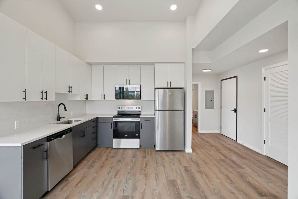 Spacious kitchen with stainless appliances and tall ceilings at Cartwright Apartments in Salem, Oregon