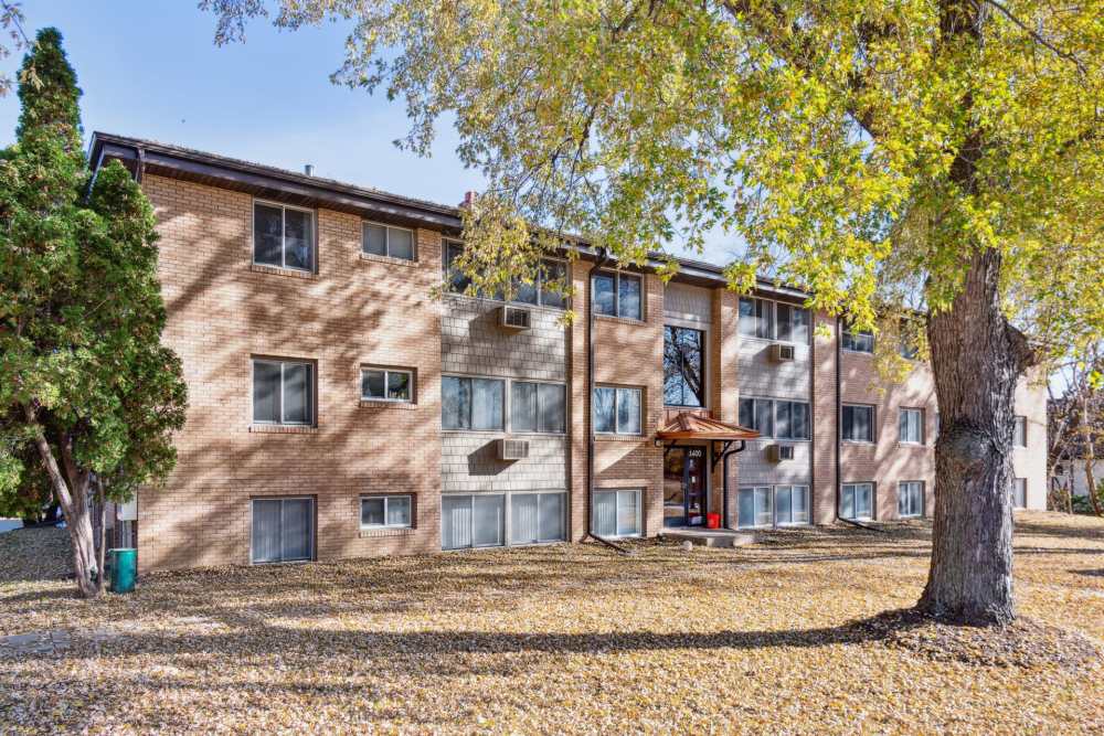Exterior view of the apartment with surrounded by trees at West End Trails in Golden Valley, Minnesota