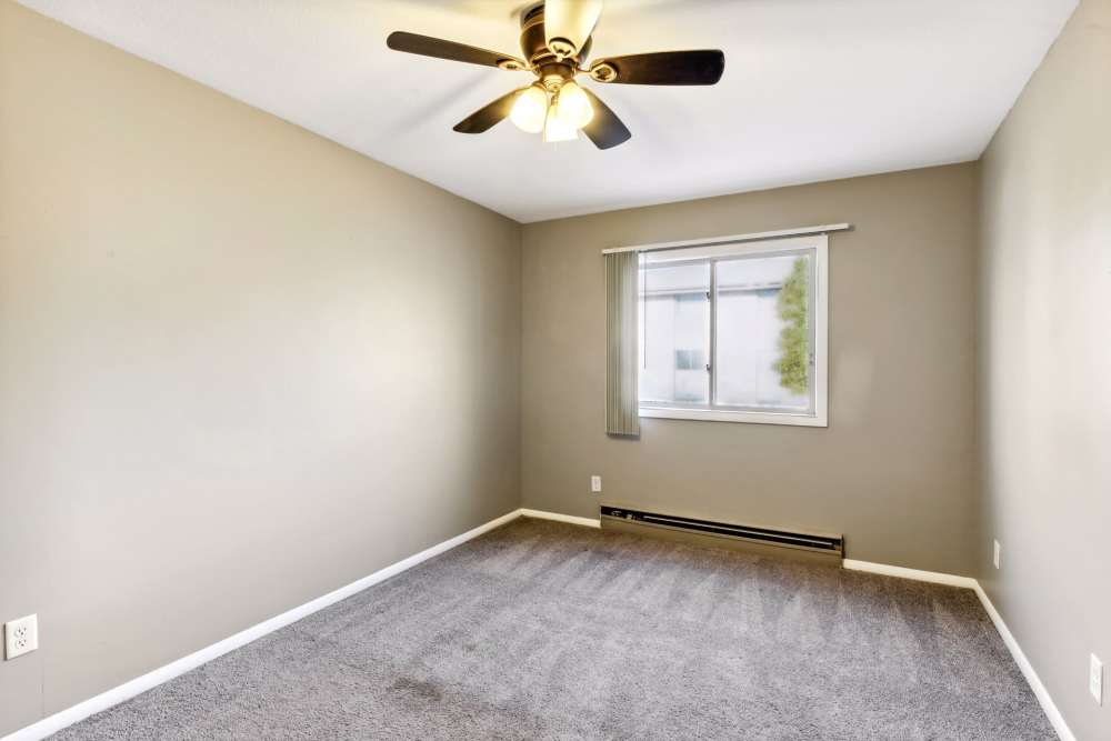 Unfurnished bedroom  with large window and ceiling fan at West End Trails in Golden Valley, Minnesota