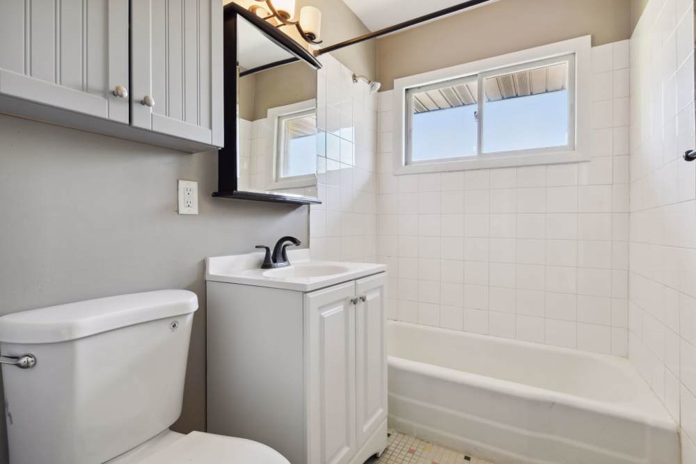 Bathroom with toilet sink and bathtub at West End Trails in Golden Valley, Minnesota
