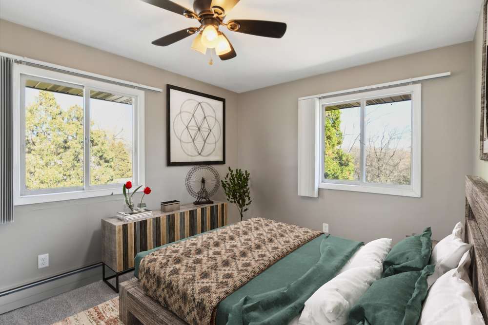 Modern bedroom with ceiling fan at West End Trails in Golden Valley, Minnesota