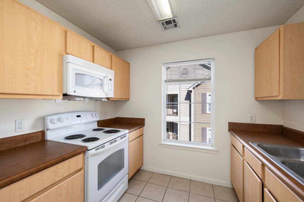 Kitchen with window and all white color appliance  at The Terraces At Copper Leaf in Nixa, Missouri