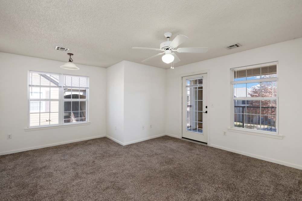 Living room with ceiling fan at The Terraces At Copper Leaf in Nixa, Missouri