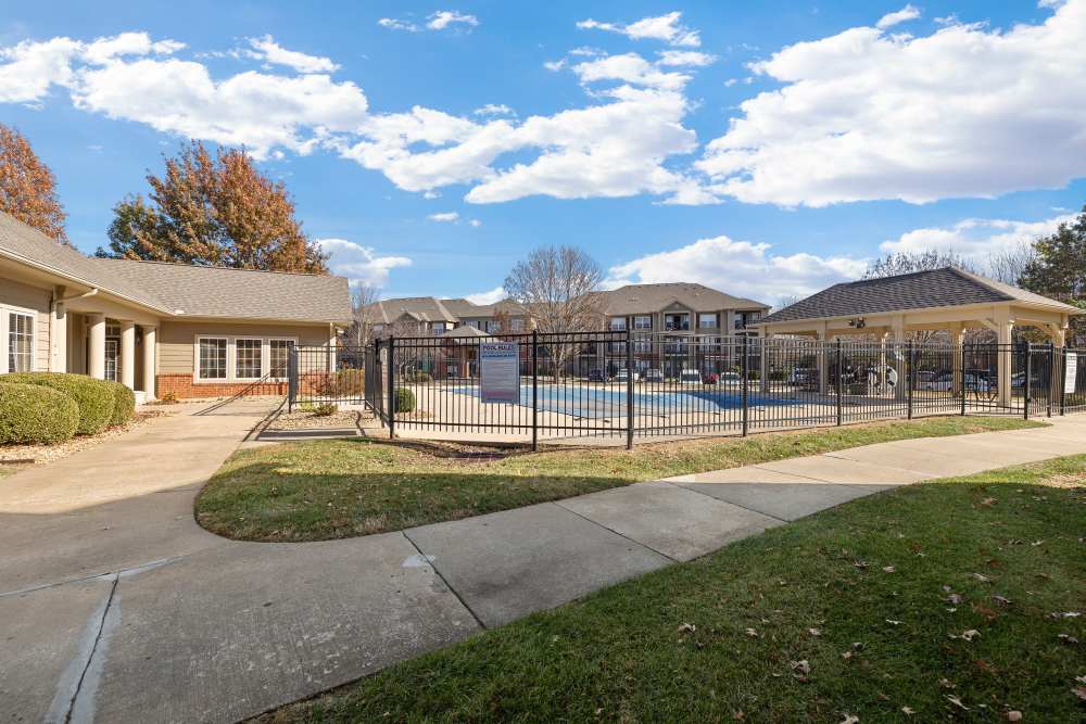 Swimming pool with fence at The Terraces At Copper Leaf in Nixa, Missouri