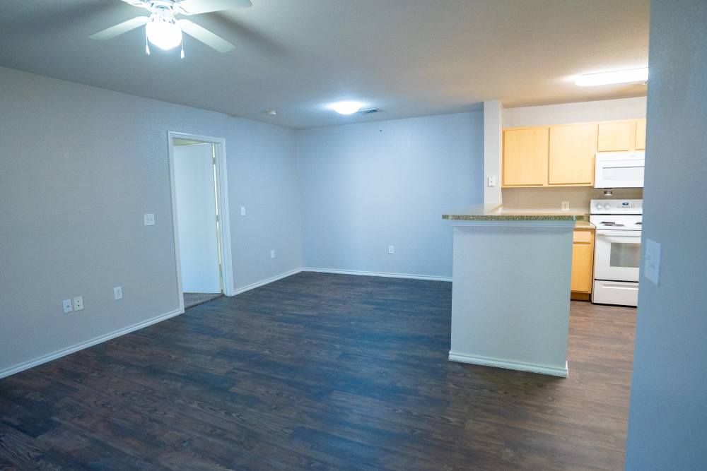 Living room with ceiling fan at Timber Village in Marshall, Texas