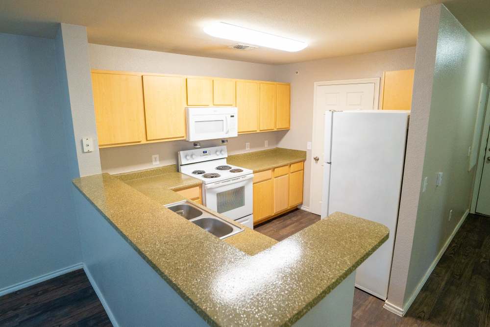 Kitchen with raised breakfast countertop at Timber Village in Marshall, Texas 