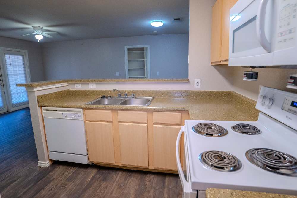 Kitchen with dishwasher  at Timber Village in Marshall, Texas