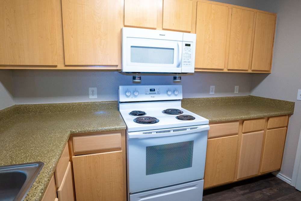 Kitchen with granite countertop at Timber Village in Marshall, Texas