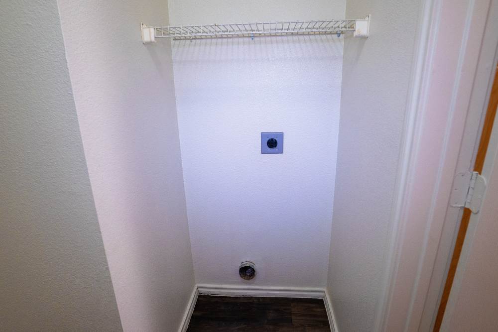 Laundry area with closet rack at Timber Village in Marshall, Texas