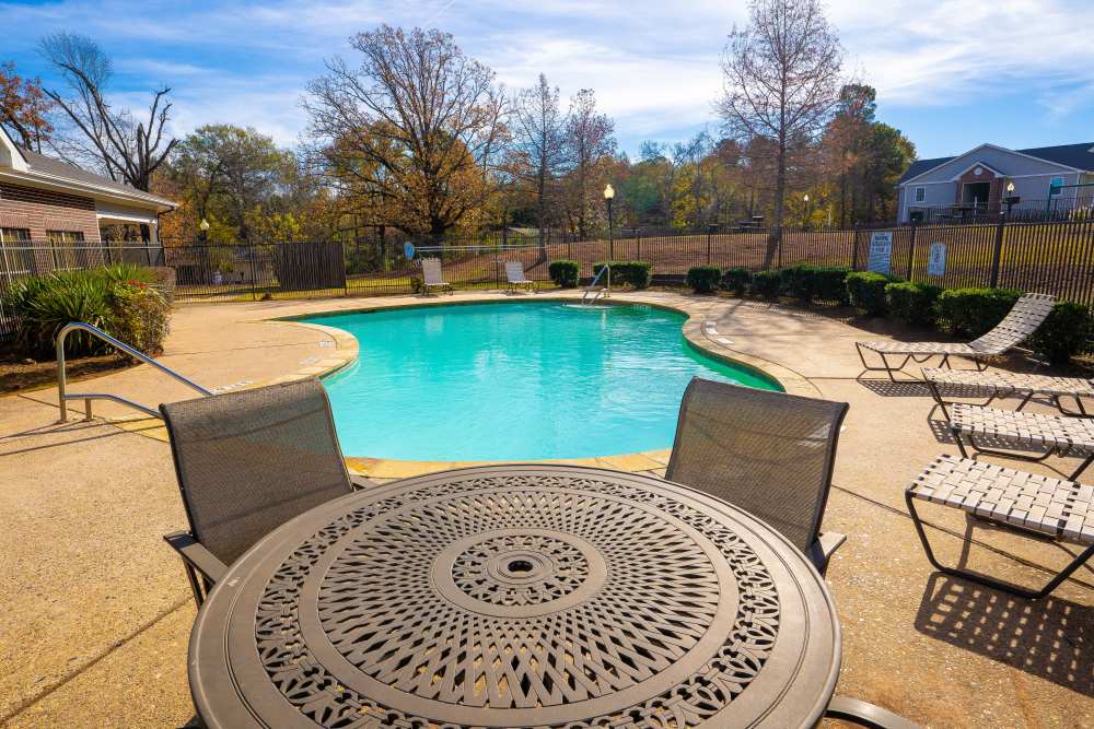 Pool with seating area at Timber Village in Marshall, Texas