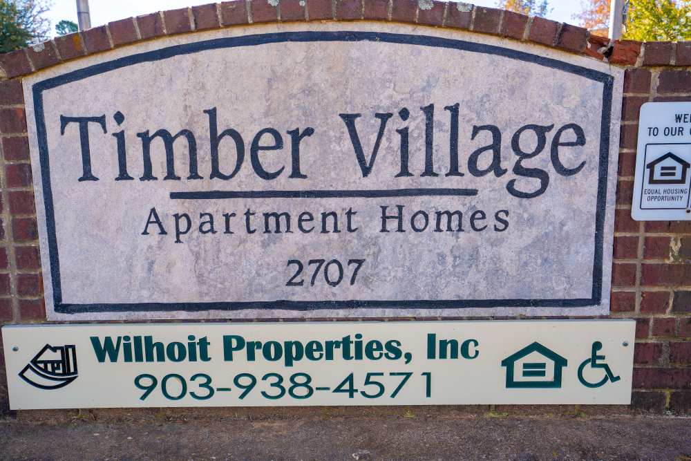 Community signage board at Timber Village in Marshall, Texas