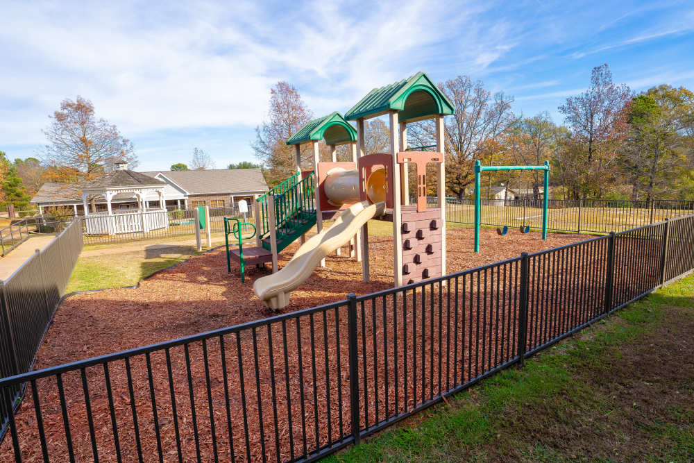Playground guarded with railing at Timber Village in Marshall, Texas
