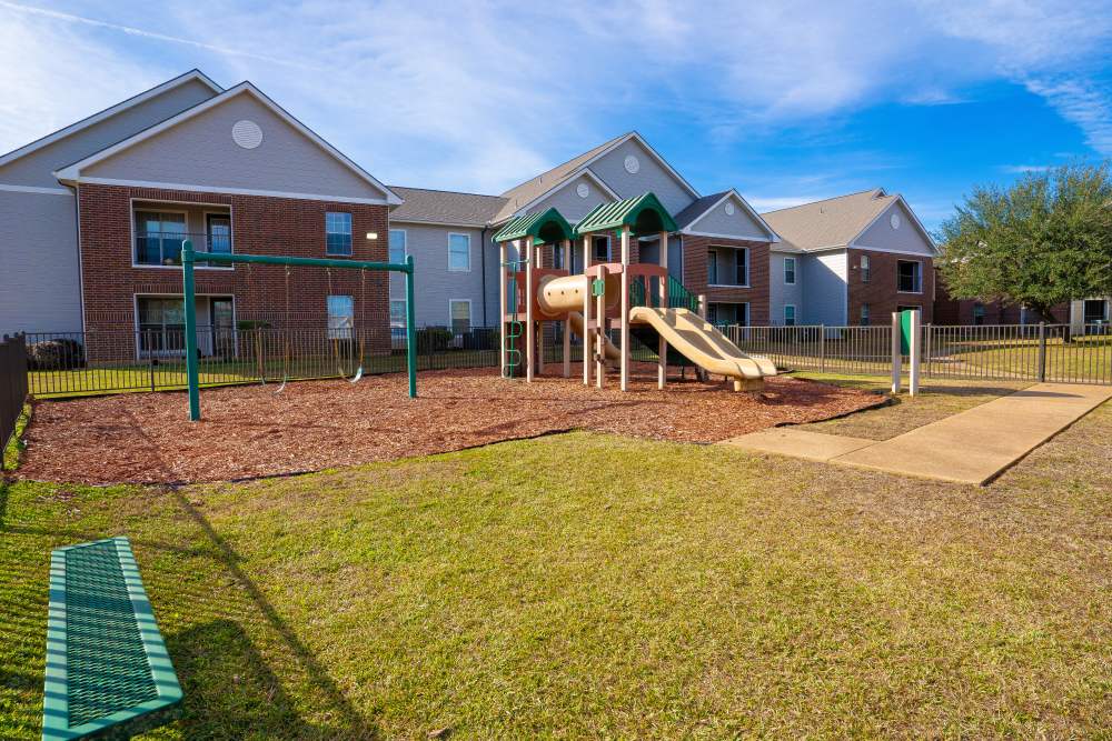 Playground with swing at Timber Village in Marshall, Texas